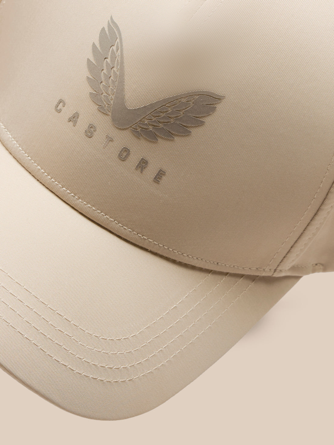 Close-up of the beige mushroom cap showing an embossed wing emblem on the crown
