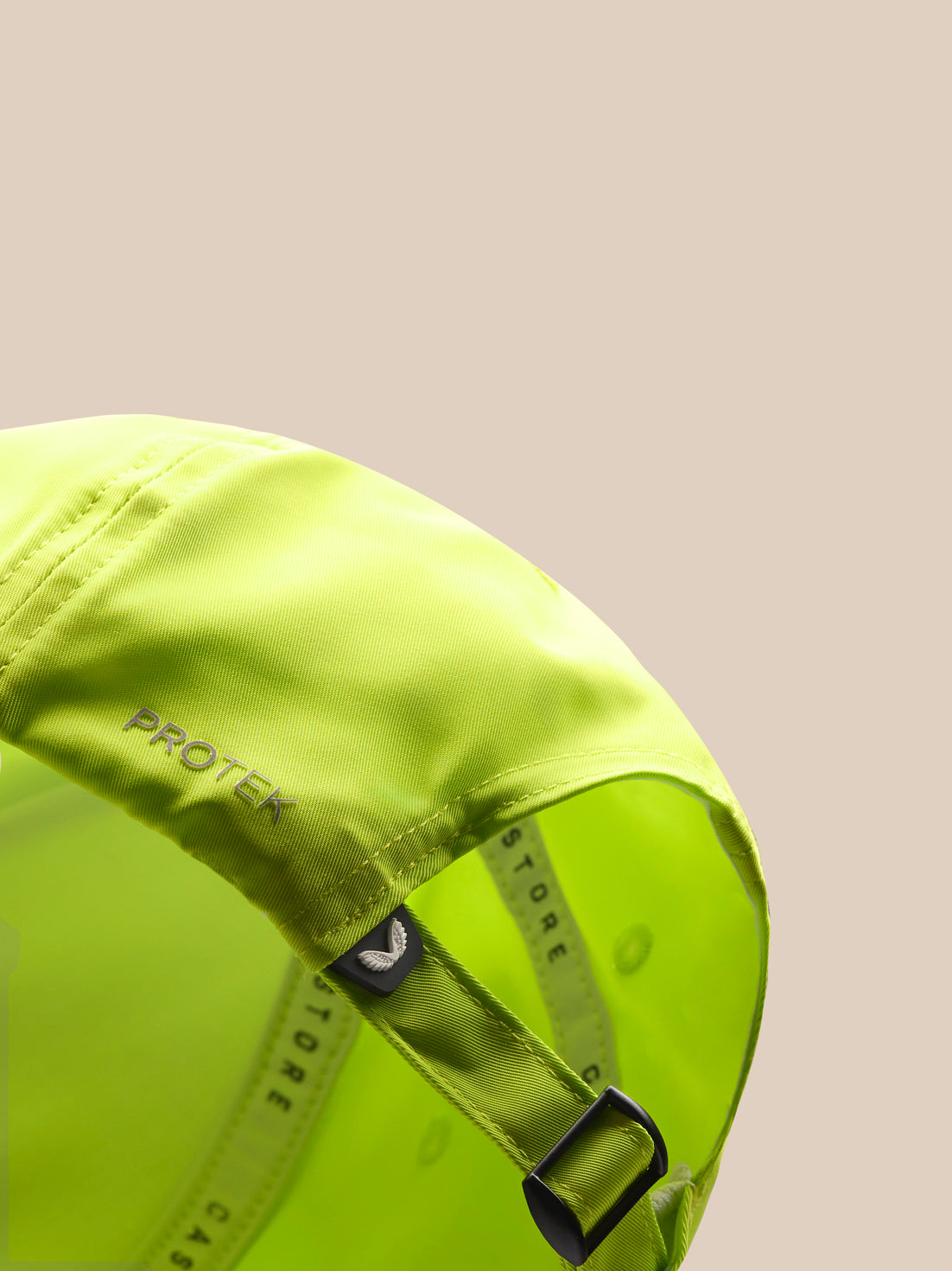 Close-up of lime neon cap back with adjustable strap and Protek branding