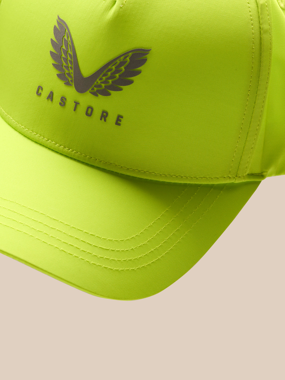 Front close-up of lime Active Cap with Castore winged logo and curved brim