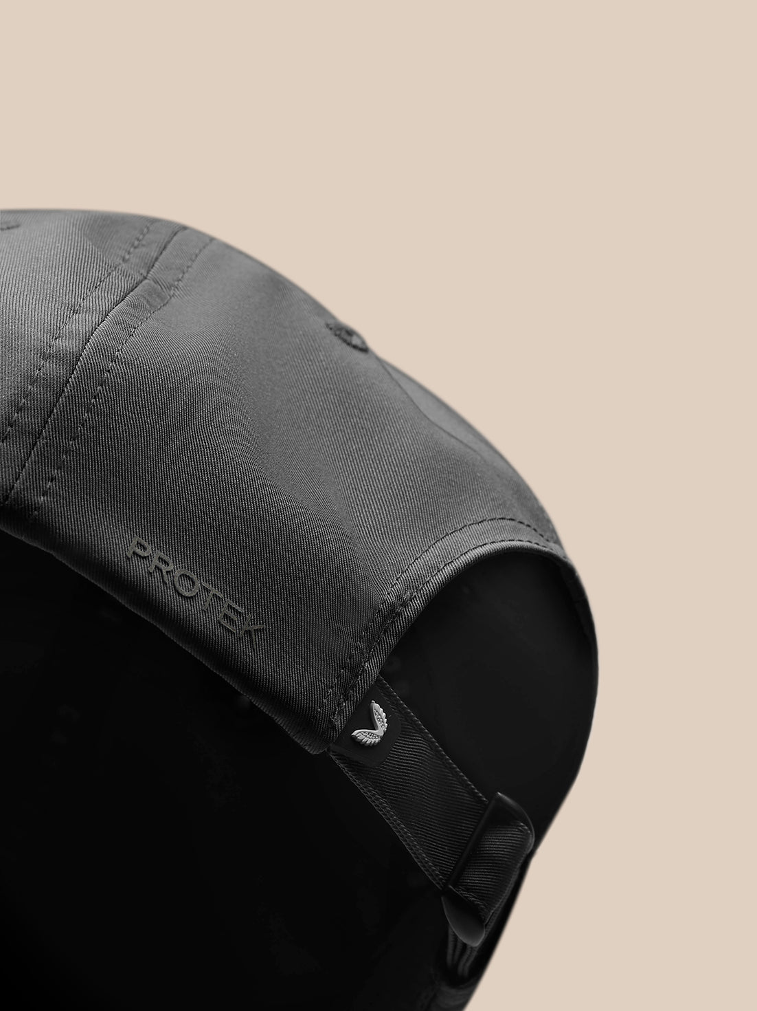 Back view of charcoal Castore cap showing adjustable strap and curved brim