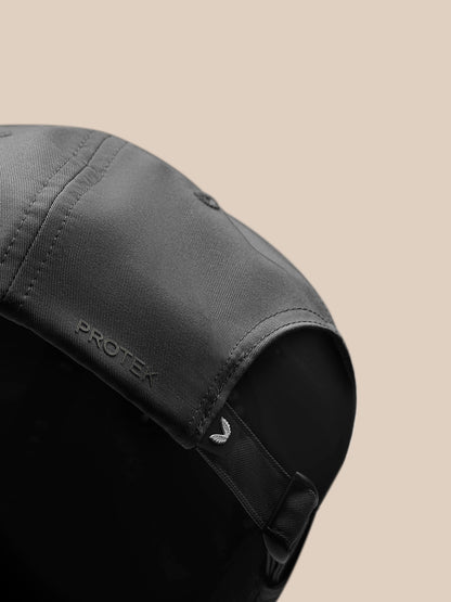 Back view of charcoal Castore cap showing adjustable strap and curved brim