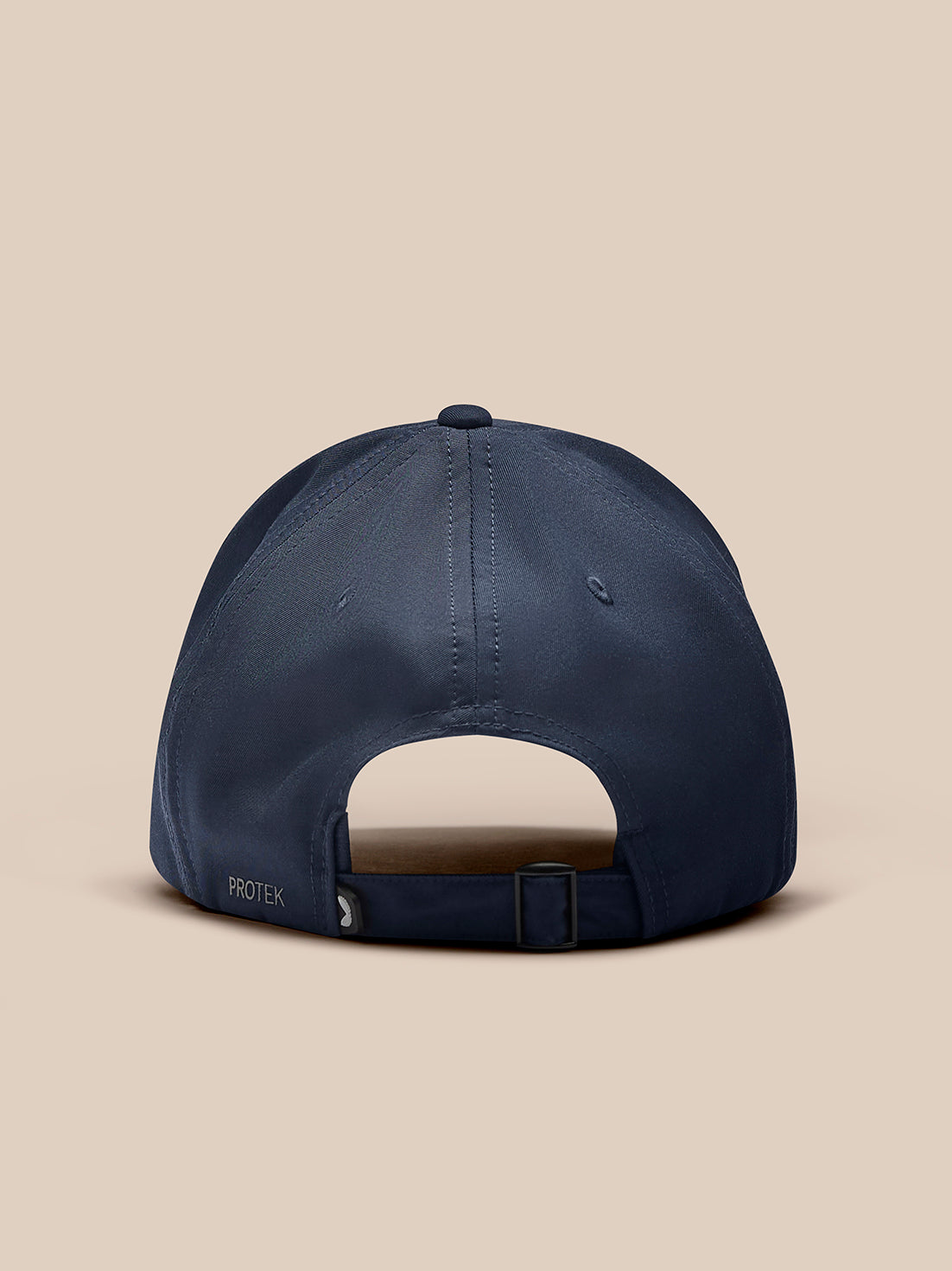 Rear view of navy cap with adjustable strap and buckle and PROTEK label