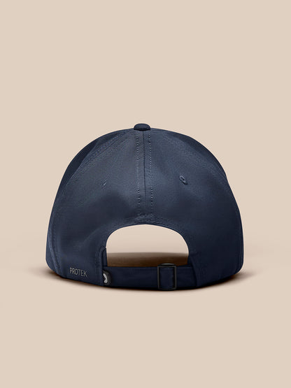 Rear view of navy cap with adjustable strap and buckle and PROTEK label