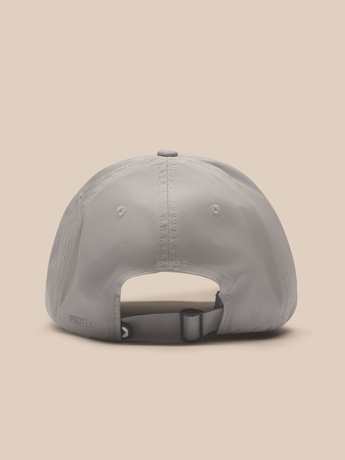 Rear view of Rock Grey Castore Active Cap on a model showing the adjustable back strap