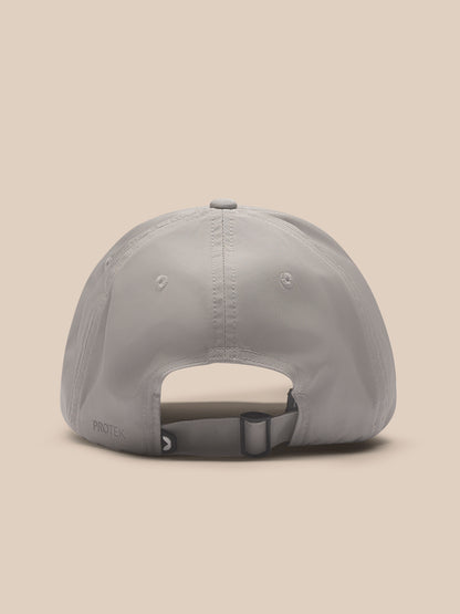 Rear view of Rock Grey Castore Active Cap on a model showing the adjustable back strap