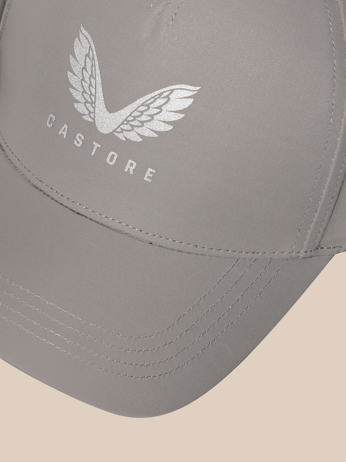 Rock Grey Active Cap close-up showcasing the silver Castore logo with wings