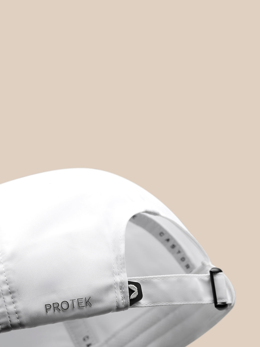 Close-up of the back strap showing the adjustable buckle and PROTEK branding on a white cap.