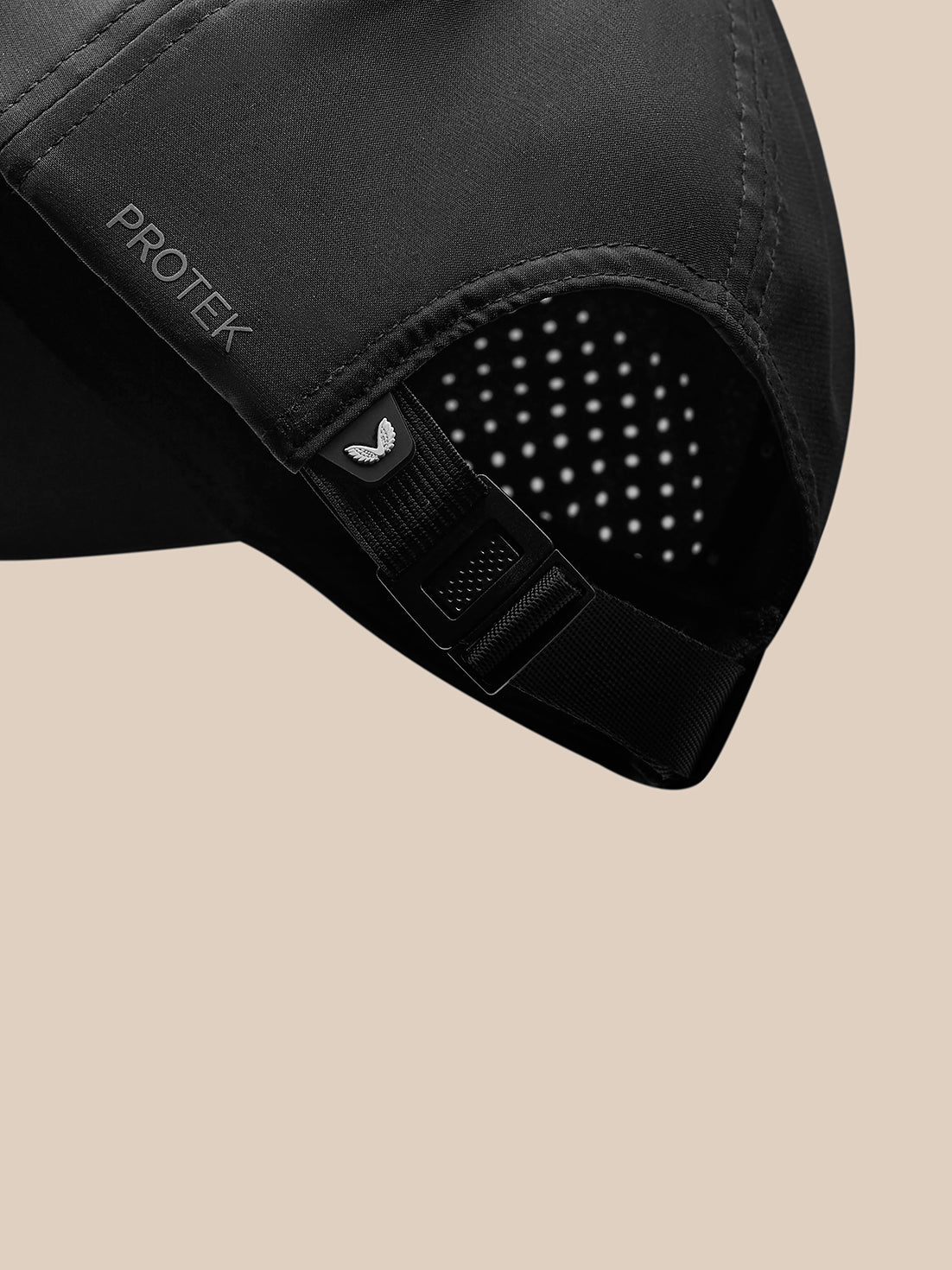 Close-up of back of black Zone Cap showing PROTEK branding and adjustable strap buckle