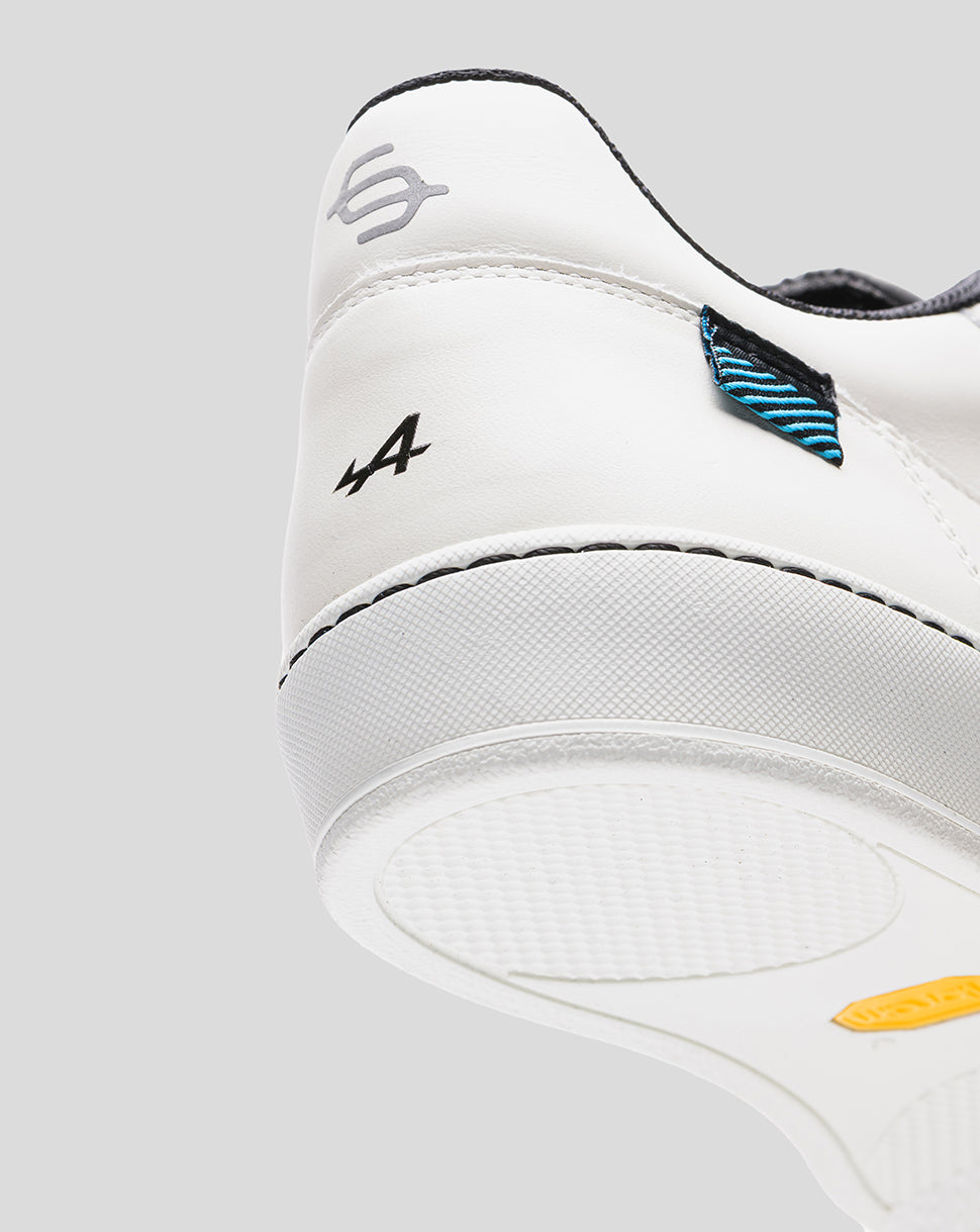Rear side view of white Alpine Endstate sneaker with blue striped heel patch and A4 logo.
