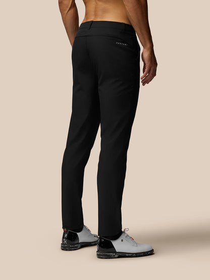 Back view of black Club Golf Trousers on a male model with a rear pocket and Castore branding at the right hip