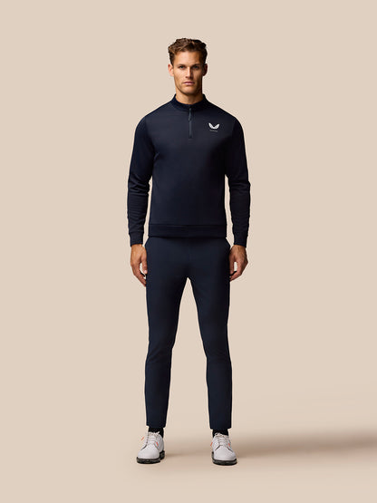 Full-body front view of a male model in midnight blue golf attire with matching trousers.