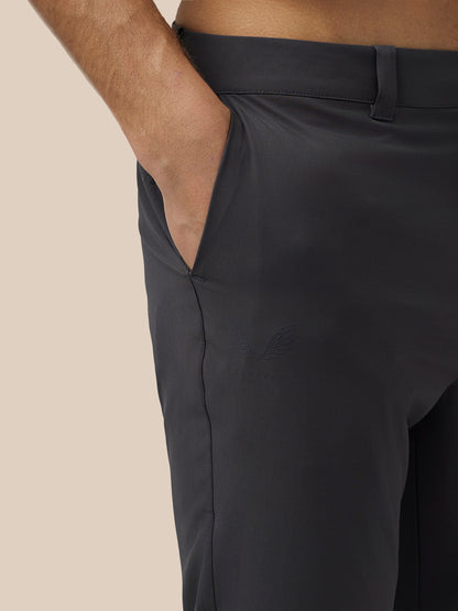 Close-up of front pocket area on grey golf trousers with a hand in the pocket and Castore branding