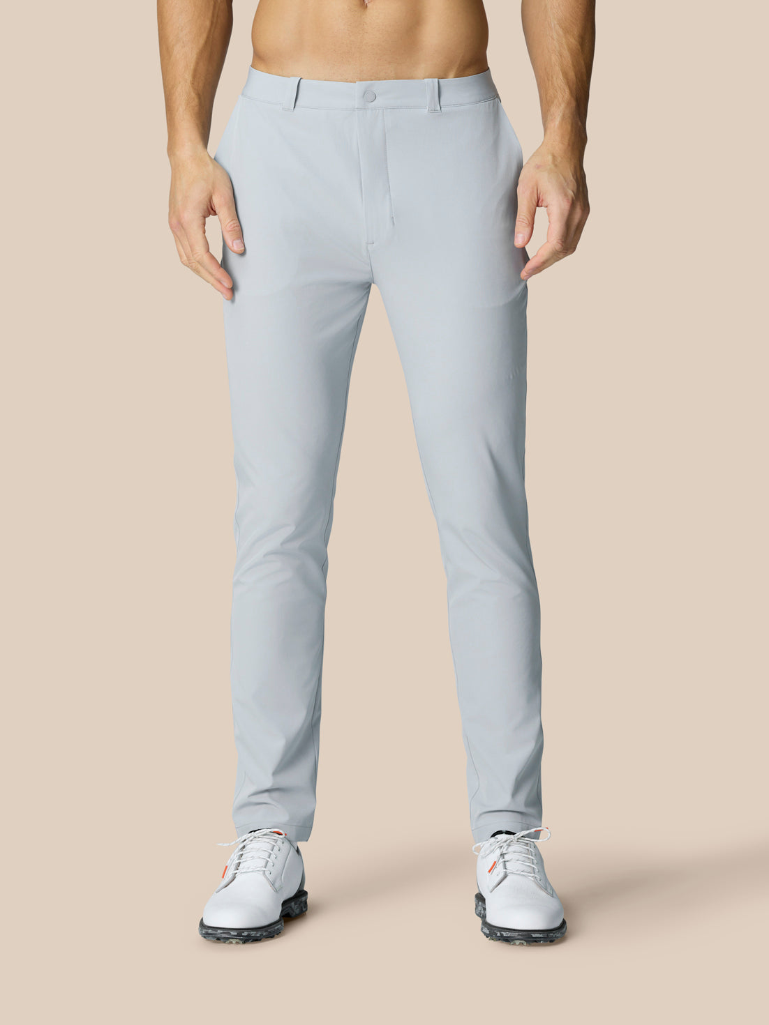 Front view of mid grey Golf Club Trousers on a model highlighting slim fit with belt loops and pockets.