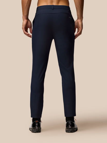 Rear view of navy Golf Club Trousers paired with white sneakers, highlighting back pocket and streamlined fit.
