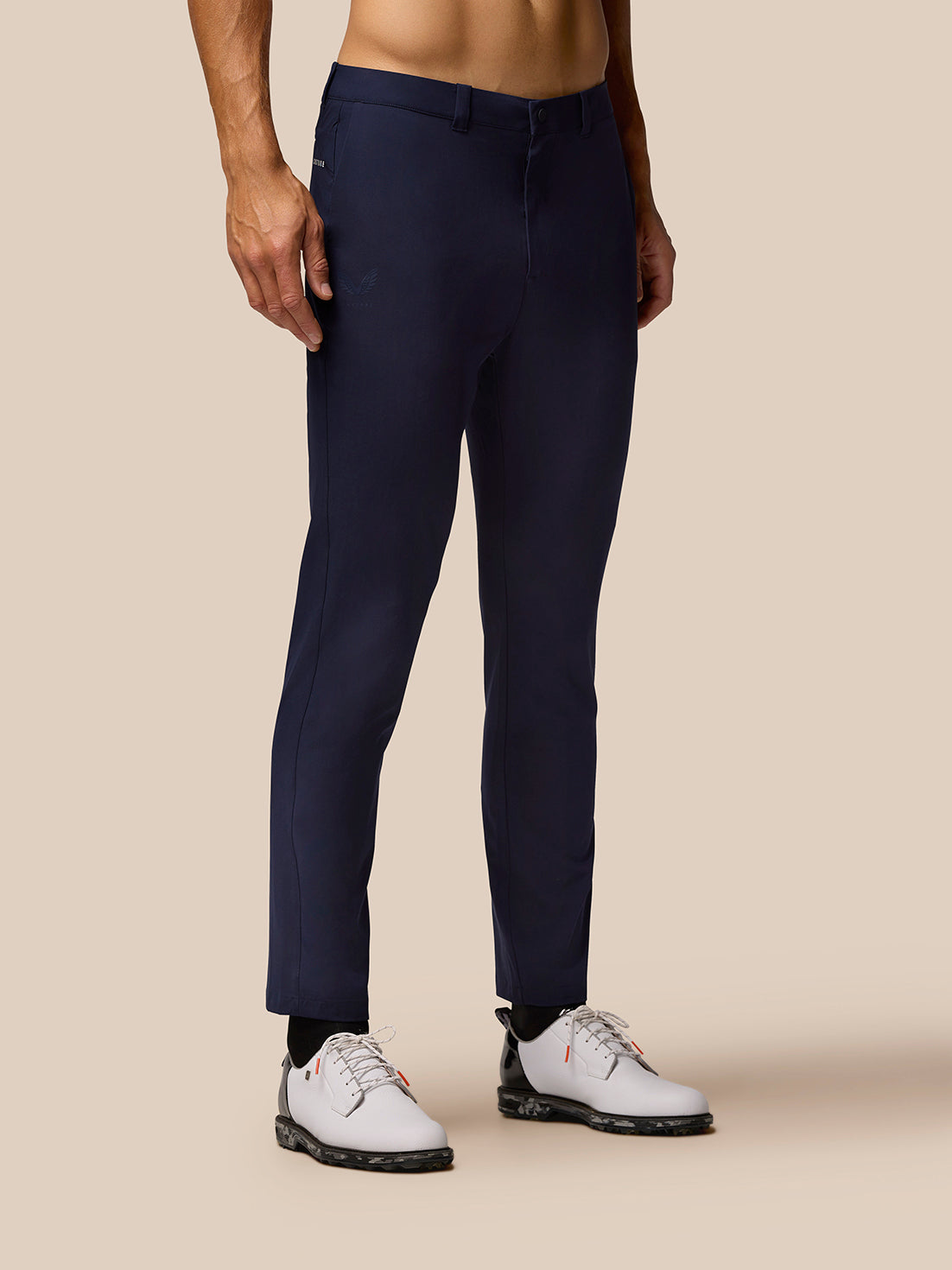 Front view of a man wearing Midnight Navy Golf Lightweight Club Trousers with white sneakers