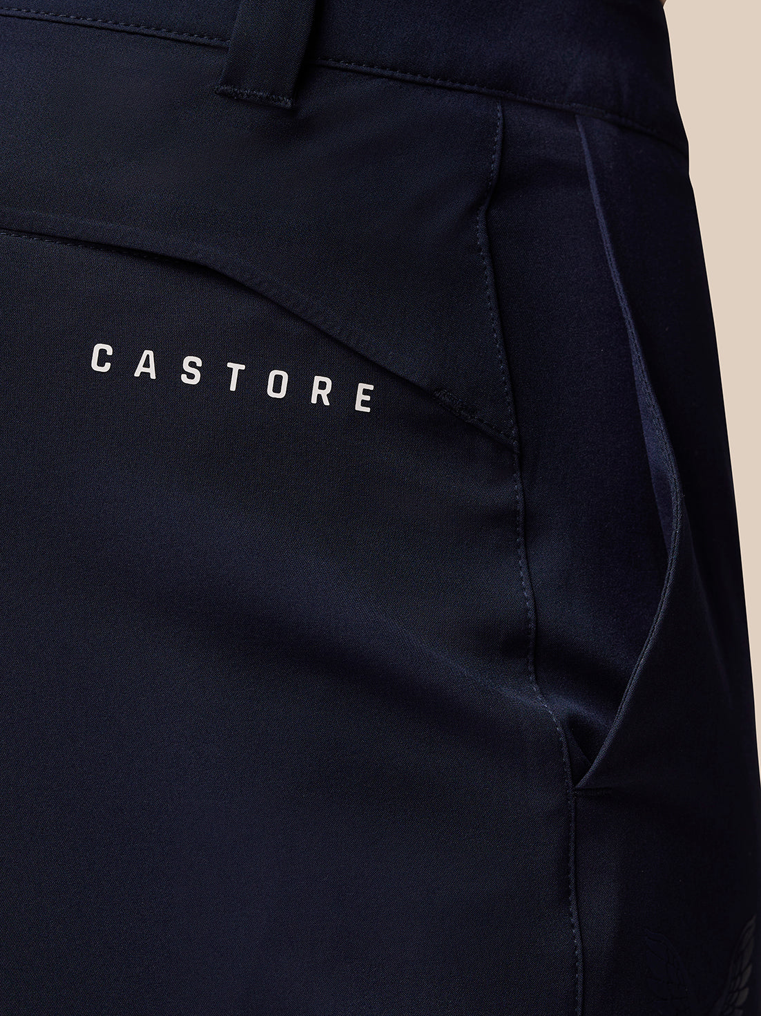 Close-up of the back pocket area on Midnight Navy Golf Lightweight Club Trousers with Castore branding