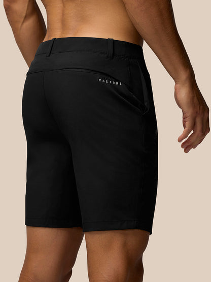 Back view of black golf shorts on a model, showing belt loops and Castore branding on thigh and rear.