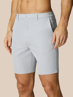 Close up of light grey golf shorts waist area showing belt loops and front seam
