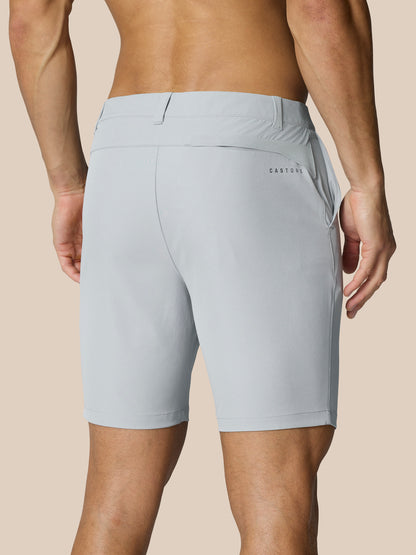 Back view of a man wearing light grey golf shorts with belt-loop waistband and Castore branding on the right thigh and rear.