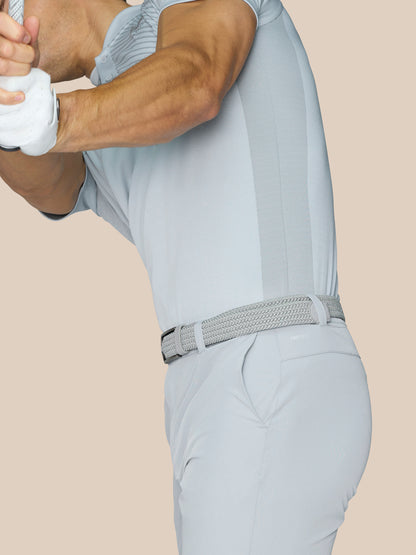 Side view of a male model wearing mid grey golf shorts with a woven belt, highlighting lightweight stretch fabric and pockets.