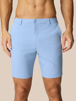 Front view of a man wearing sky blue Golf Club Shorts with belt loops and side pockets