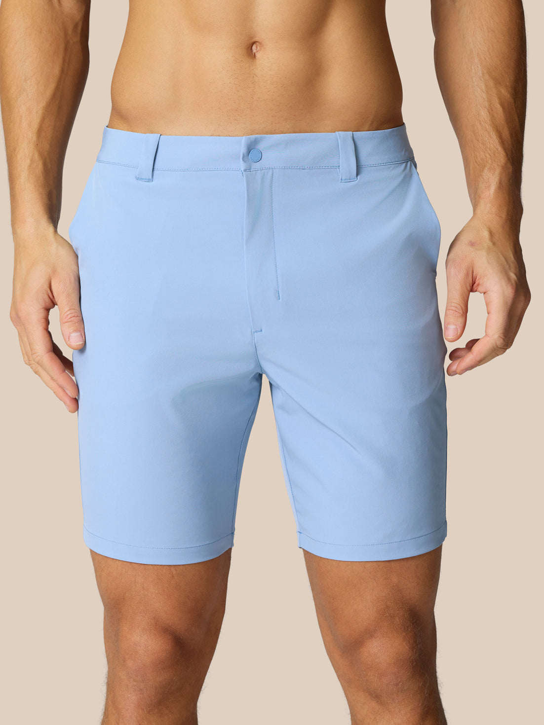 Front view of a man wearing sky blue Golf Club Shorts with belt loops and side pockets