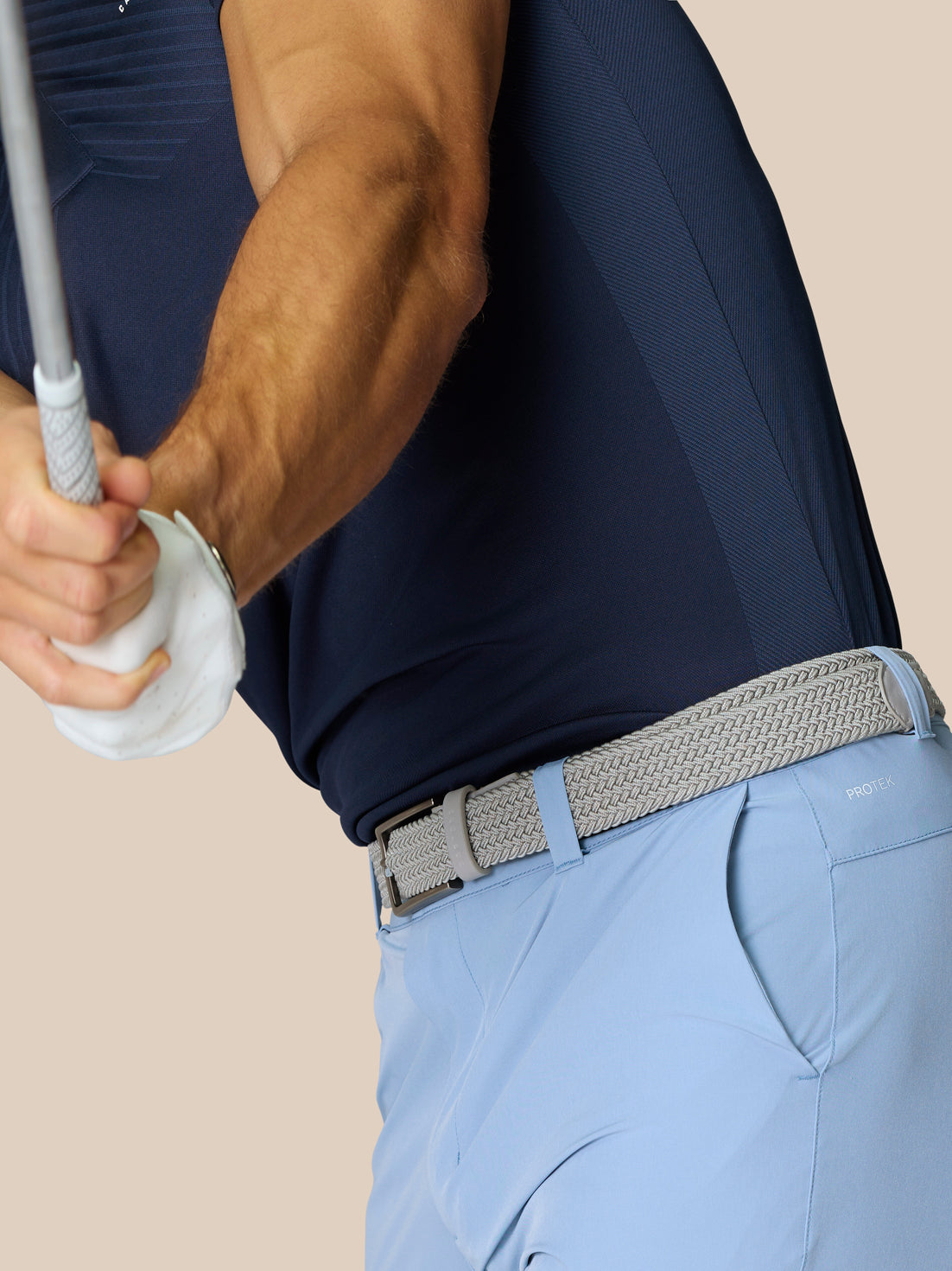 Back view of light blue golf shorts with braided belt and right rear branding
