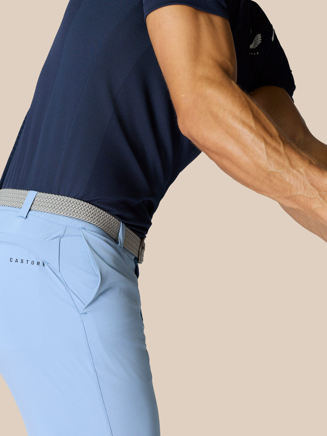 Sky blue Castore golf shorts with braided belt, visible belt loops and branding on the right thigh