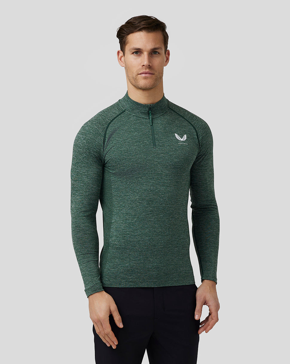Male model wearing pine grey body mapped seamless quarter zip top with stand collar and Castore logo on chest