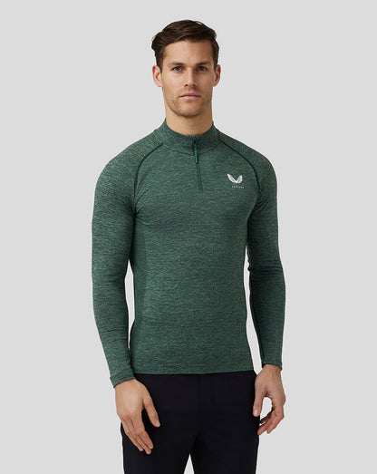 Male model wearing pine grey body mapped seamless quarter zip top with stand collar and Castore logo on chest