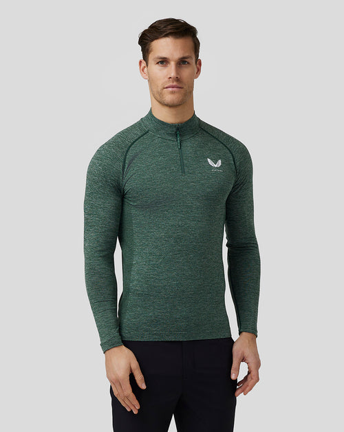 Male model wearing pine grey body mapped seamless quarter zip top with stand collar and Castore logo on chest