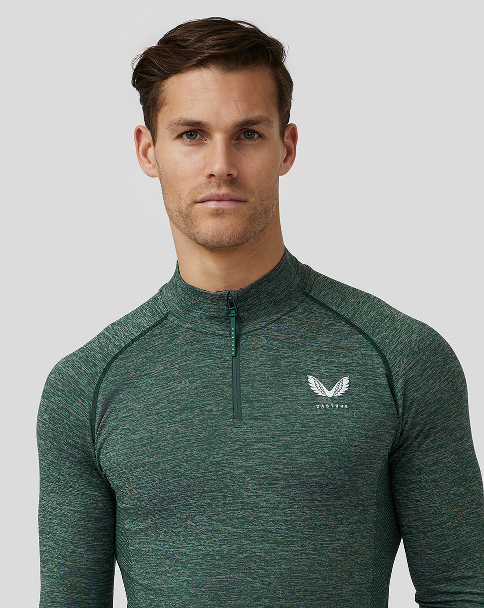 Close-up of pine grey body mapped seamless top showing quarter zip and Castore logo on the left chest.