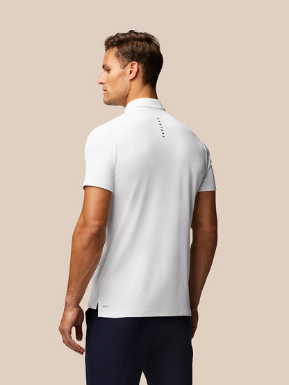 Male model wearing white Golf Club Essential Polo front view with Castore branding on left chest