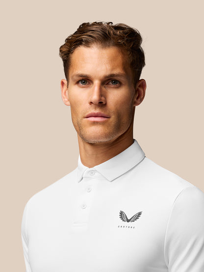 Close-up of the white golf polo upper torso with collar and left chest Castore logo.