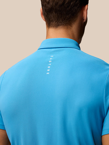 Back view of man in corn blue Club Golf Polo with CASTORE branding running down the back.
