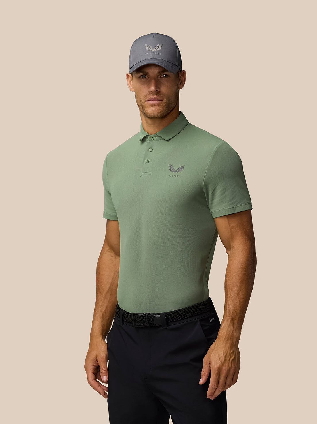 Male model in Thyme Golf Club Essential Polo in green with left chest logo and matching cap