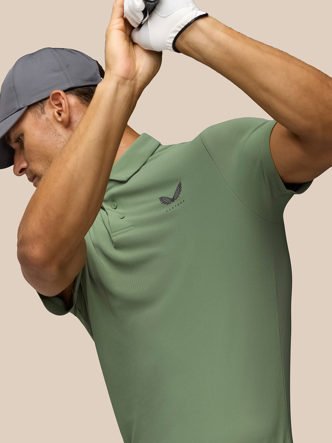 Side profile of a golfer in the Thyme Golf Club Essential Polo with Castore logo on the left chest