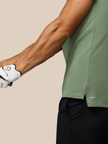 Close up of a golfer wearing the Thyme Golf Club Essential Polo with AerTek branding at the hem