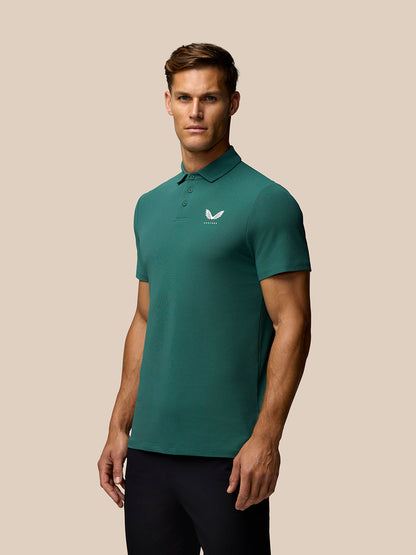 Green Club Golf Polo on a model with white Castore crest on the left chest.