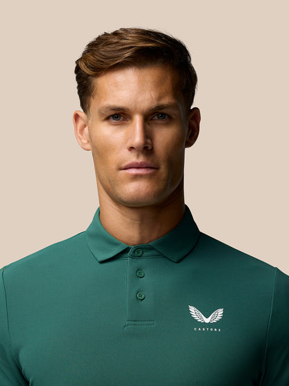 Male model wearing green Castore Club Golf Polo with three button placket and chest logo