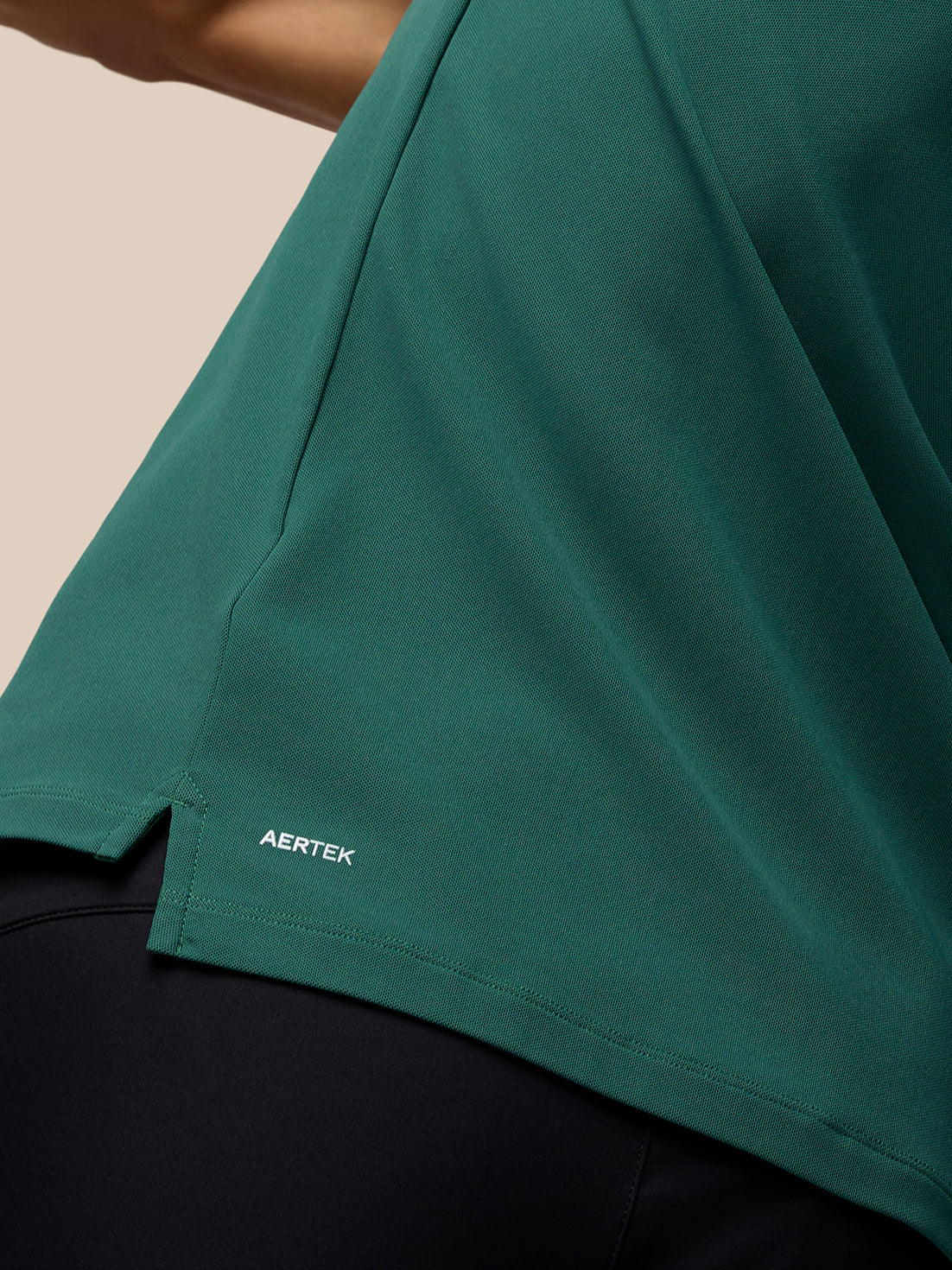 AERTEK branding on the lower back hem of the green Club Golf Polo