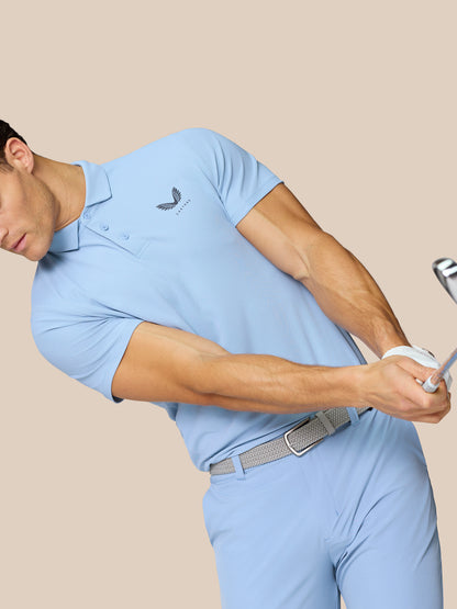 Three-quarter back view of man in sky blue golf polo with Castore logo along back