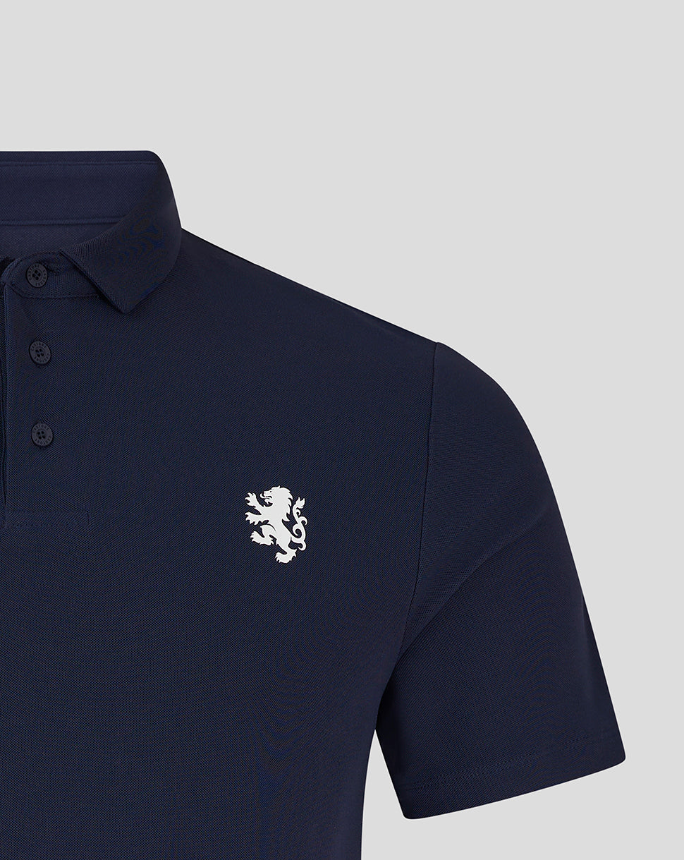 Close-up of navy polo showing white lion crest on left chest
