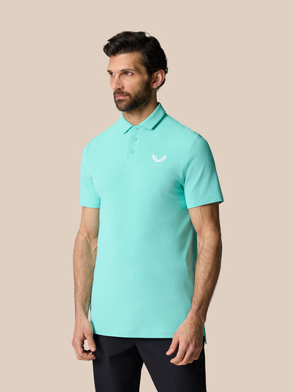 Close up of a man in the light aqua Golf Club Essential Polo showing the polo collar and chest logo.