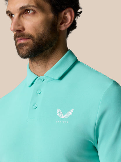 Back of turquoise Golf Club Essential Polo showing Castore branding down the back.