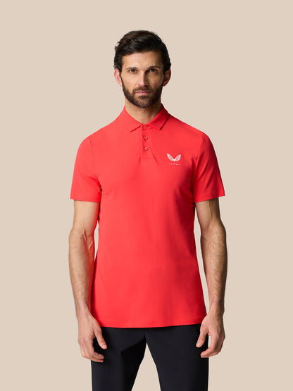 Front view of male model in red Golf Club Essential Polo with a three button placket and Castore logo on chest