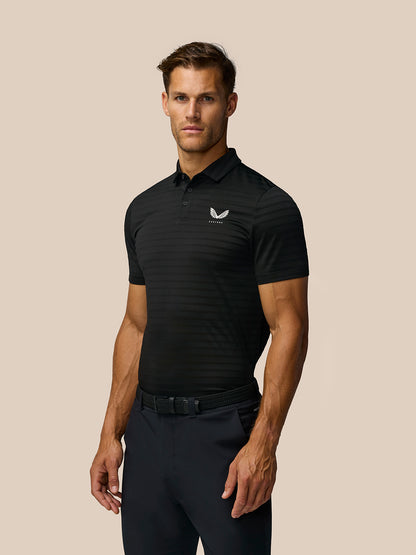 Male model wearing black golf polo with subtle horizontal stripes and Castore logo on chest.