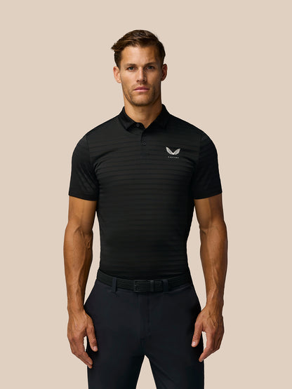 Male model wearing black Golf Pinnacle Pique Stripe Polo with white crest on chest and subtle horizontal stripes