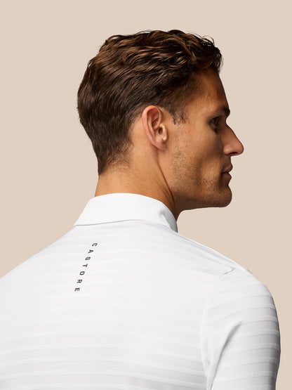Back view of white striped polo with Castore branding along the back.