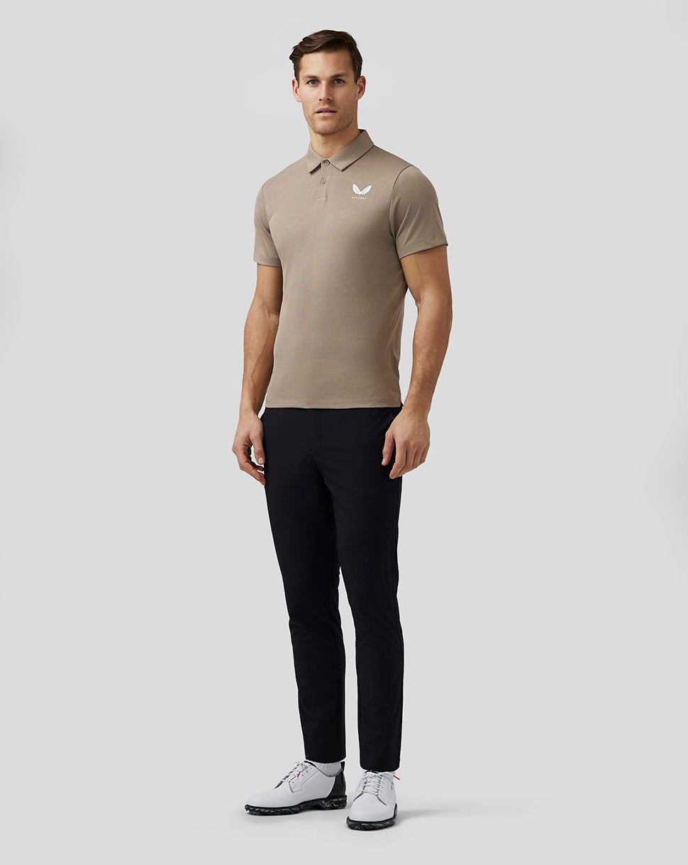 Front view of beige Pinnacle Knit Polo on a man with a small white Castore logo on the left chest
